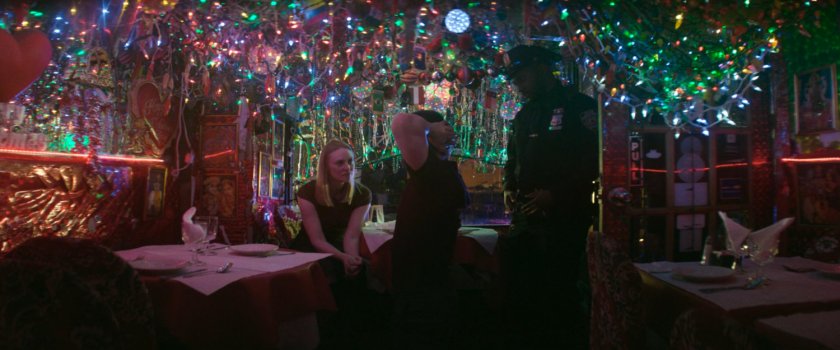 Karen, Matt, and a police officer inside Panna II Restaurant.