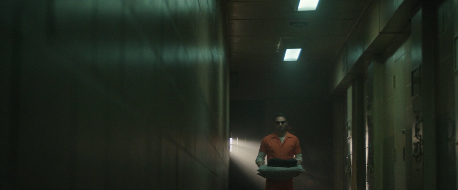 Matt walking along a hallway in Ryker's Penitentiary.