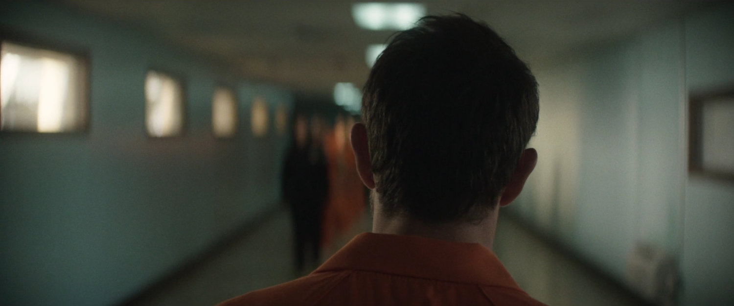 Matt walking along a hallway in Ryker's Penitentiary.