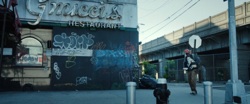 An old black veteran walking past Gnucci's Restaurant in Little Sicily.