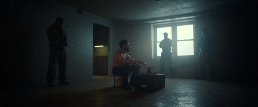 Frank surrounded by the ghosts of his buddies in his apartment.
