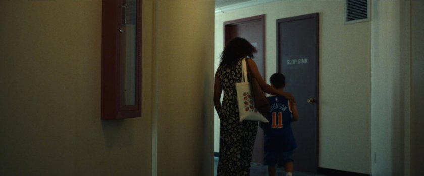 Isaiah and his mom in the hallway outside Frank's apartment.