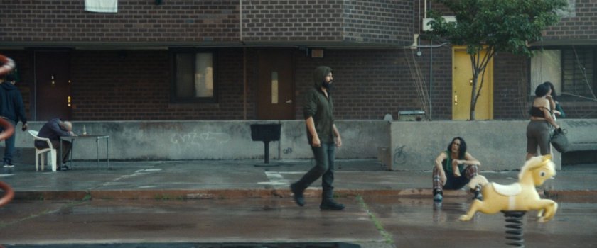 Frank walking across the quad in front of his apartment building.