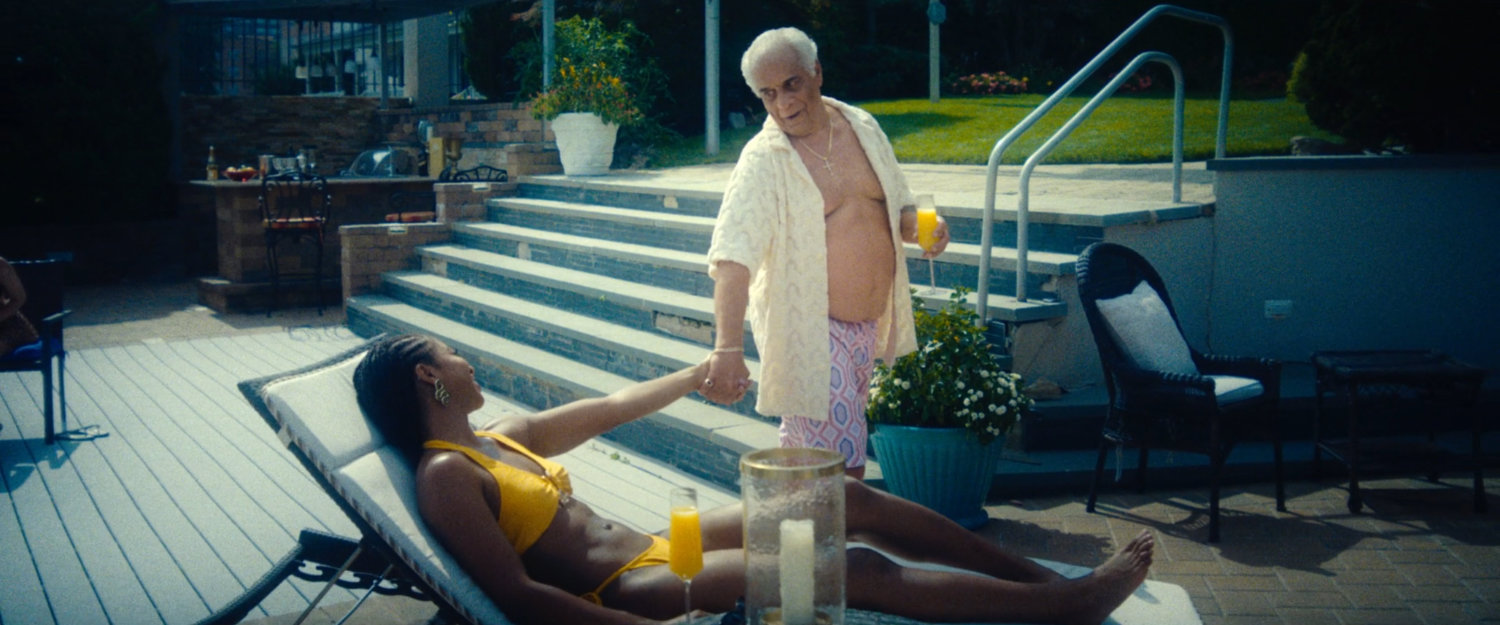 Benny Gnucci and a woman on the patio of his mansion.