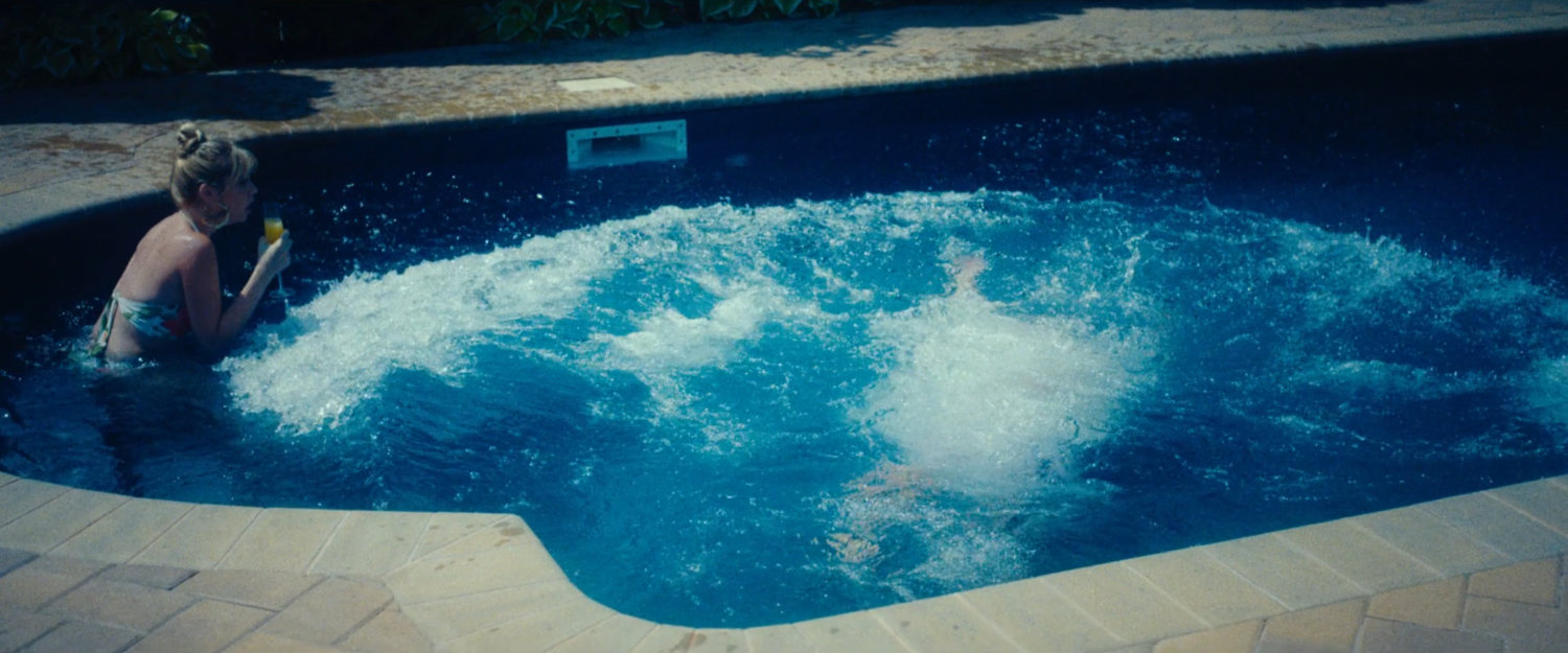 Benny Gnucci and a woman in the pool of his mansion.