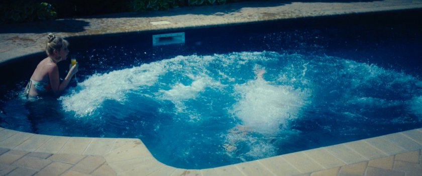 Benny Gnucci and a woman in the pool of his mansion.