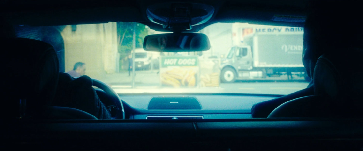 A hot dog cart blocking the Gnucci Limo from driving as seen from inside.
