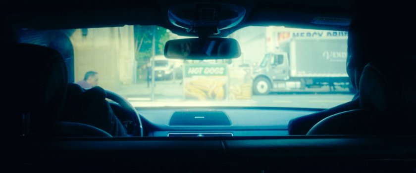 A hot dog cart blocking the Gnucci Limo from driving as seen from inside.