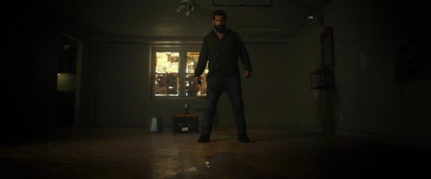Frank is his barren apartment.