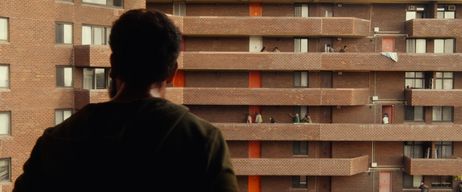Frank watching criminals attack his neighbors at his apartment building.