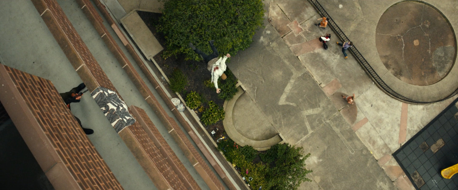 Frank tossing a man off a balcony at his apartment building.