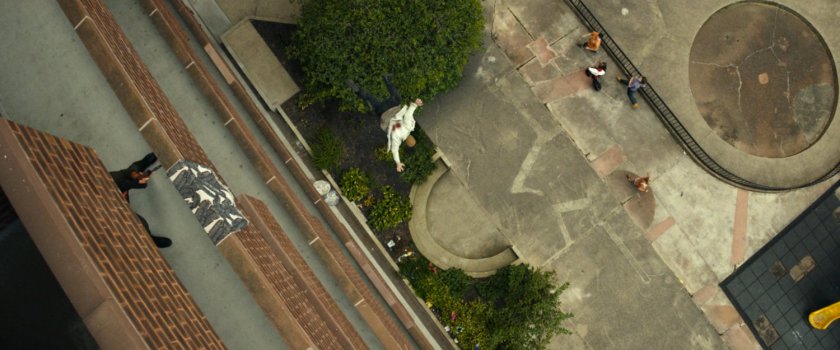 Frank tossing a man off a balcony at his apartment building.