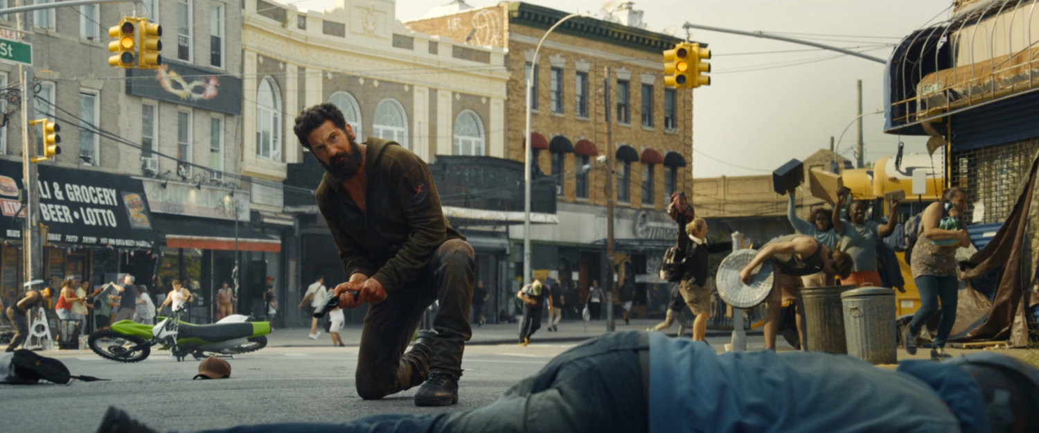 Frank kneeling on the street in Little Sicily.