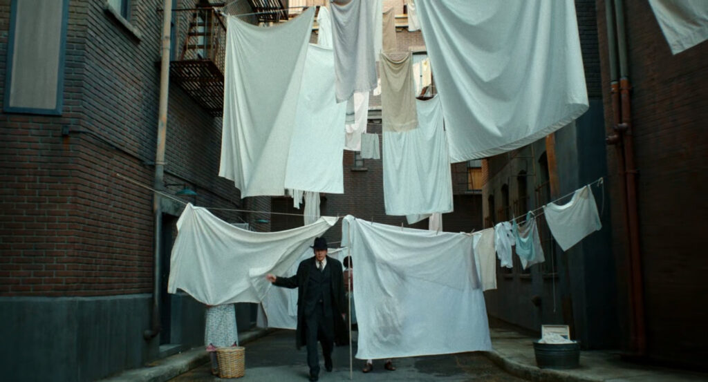 Ben Reilly emerging from an alley filled with clotheslines.