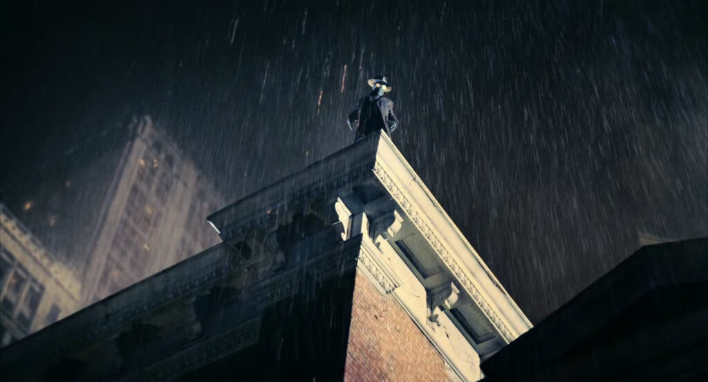 The Spider standing on the edge of a roof in the rain.
