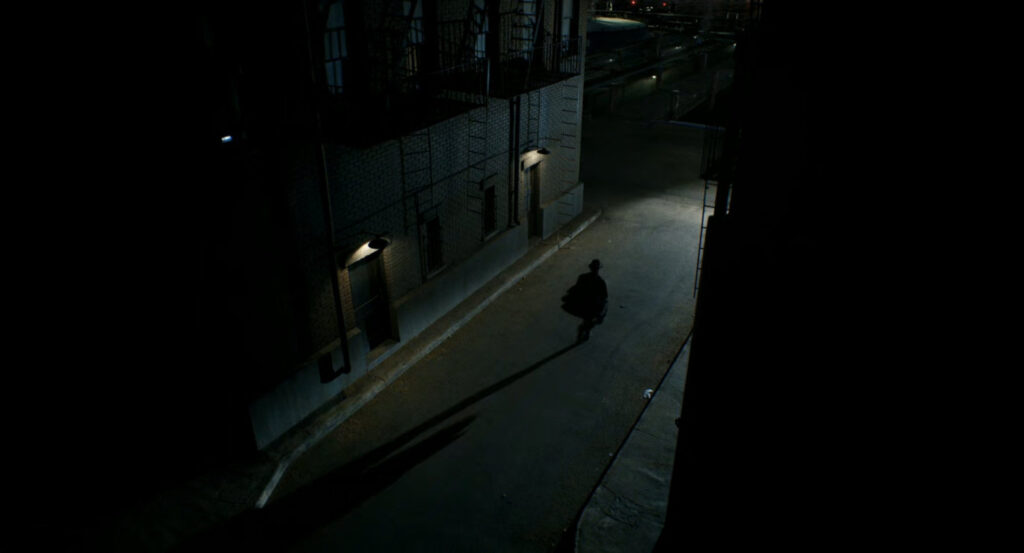 Ben running through an alley towards a Standard Oil refinery.