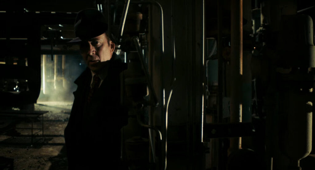 Ben in the shadows of a Standard Oil refinery.