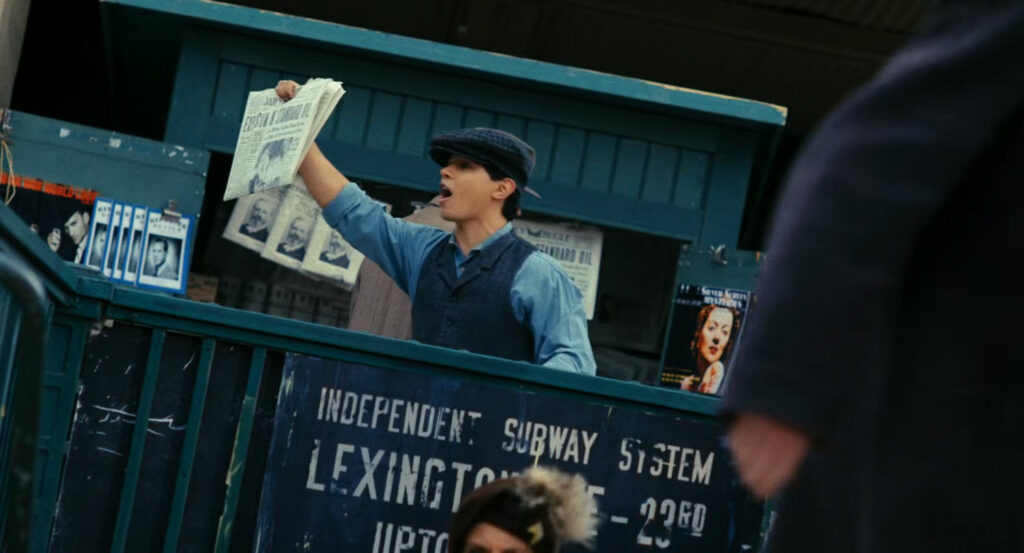 Newsboy shouts headlines outside a subway exit.