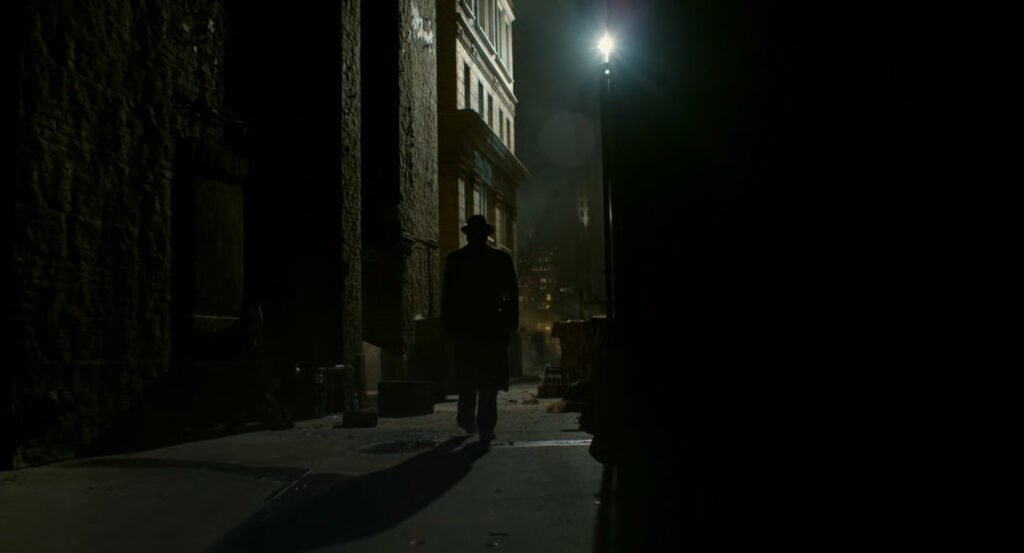 Ben in a dark alley by a construction site.