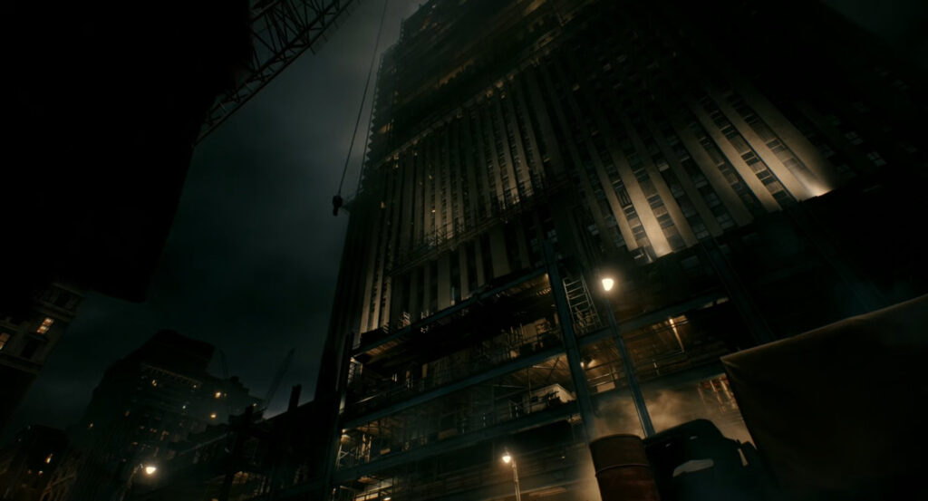 A building under construction at night.