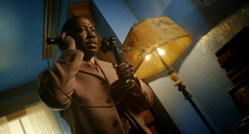 Robbie on the phone in his apartment.