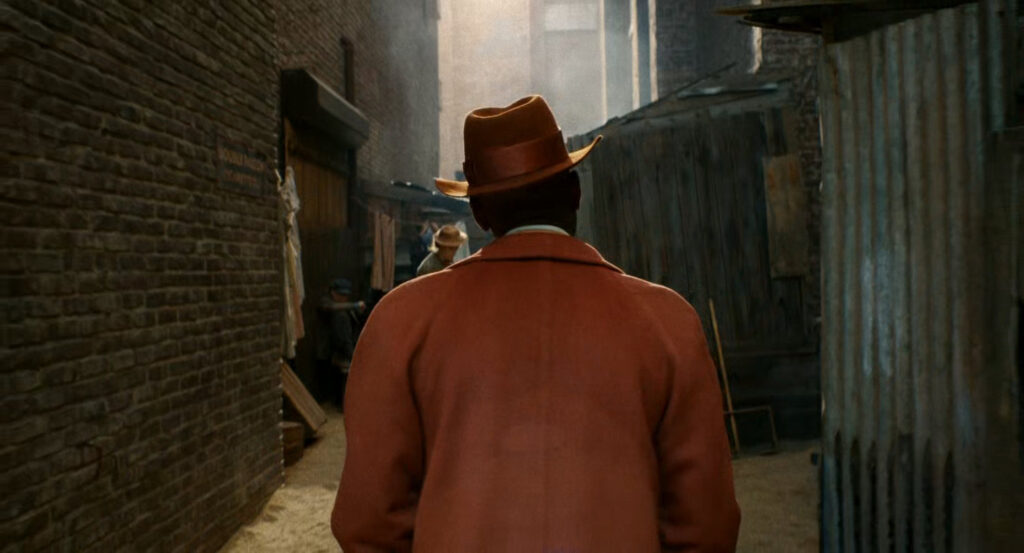 Robbie walking through a dilapidated Hooverville.