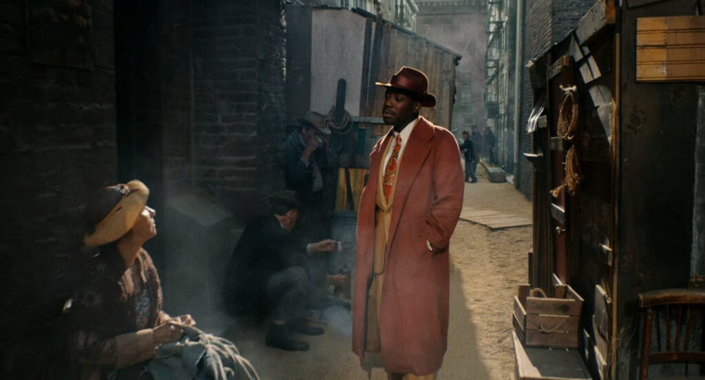 Robbie walking through a dilapidated Hooverville.