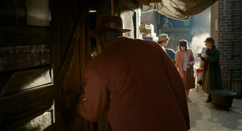 Robbie walking through a dilapidated Hooverville.