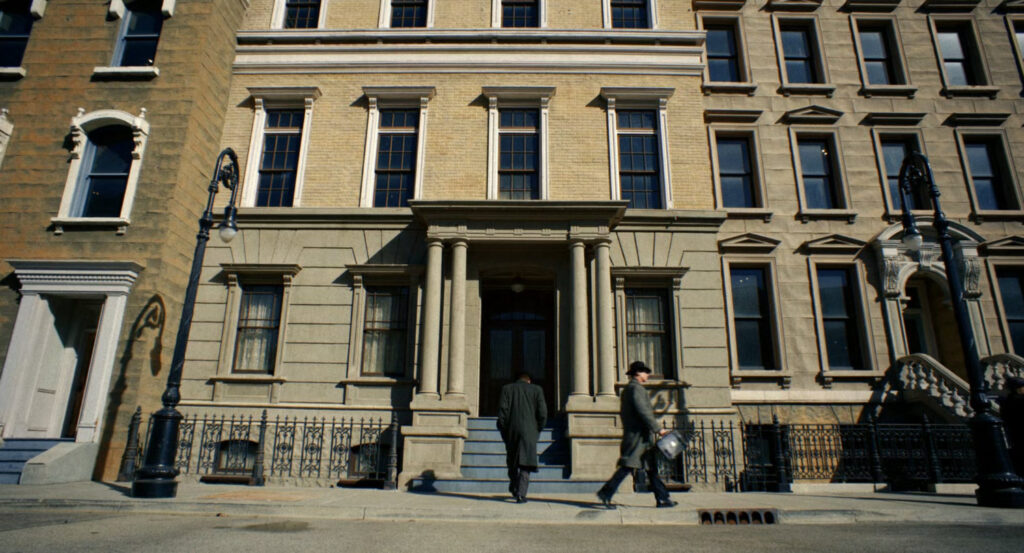 Ben entering his old apartment building.
