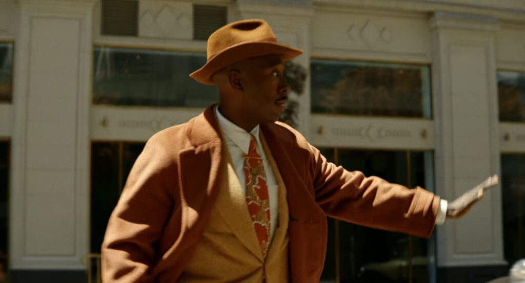 Robbie crossing the street towards the Geoffrey Hotel.