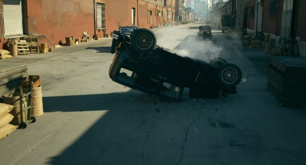 A flipped car by the docks.