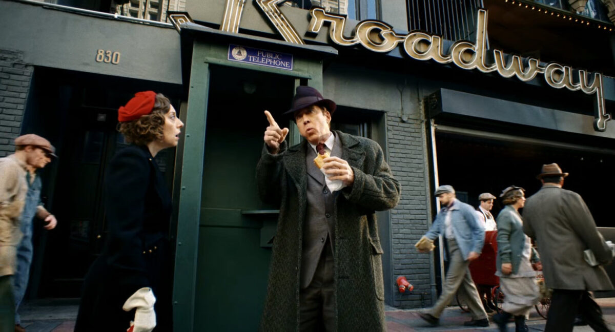 Ben directing a woman to another phone booth outside the Broadway Bar.