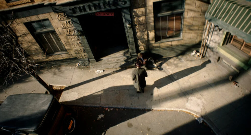 Ben asking a man on the sidewalk where to find Carmedy.