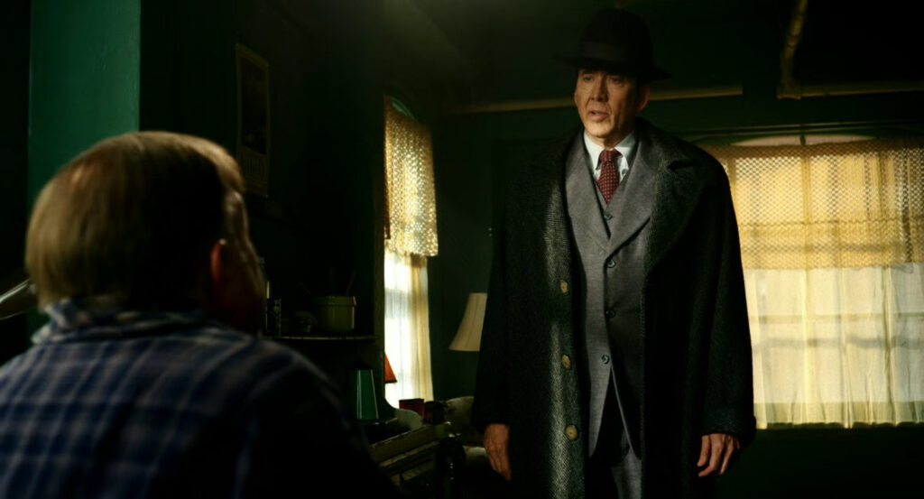 Ben talking to Carmedy in his apartment.