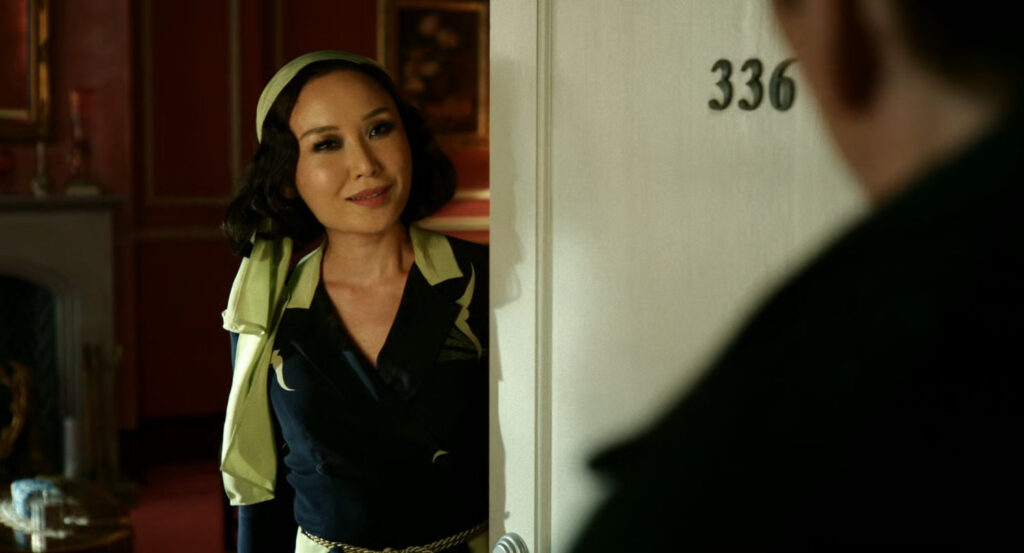 Cat answering her door to her apartment above the Alcove Theater.