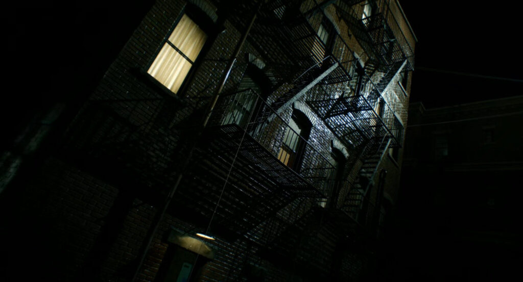 Exterior of Ben Reilly's apartment building at night.