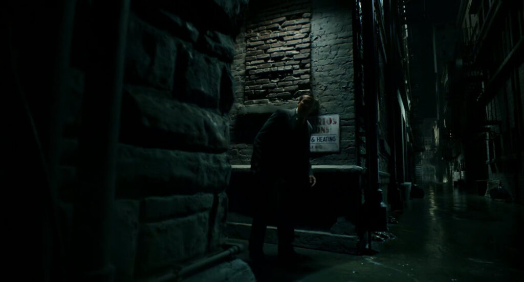 Ben in an alley by his apartment building at night.