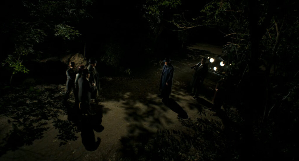Silvermane and his men holding Cat and Ben at gunpoint in the woods.