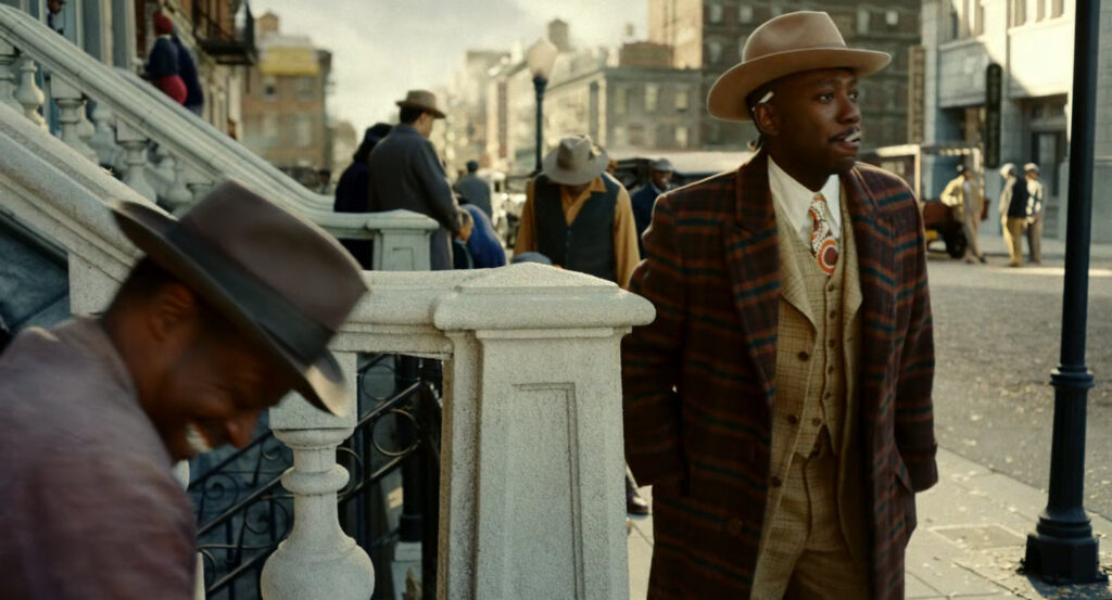 Robbie talking to a man on a stoop in Harlem.