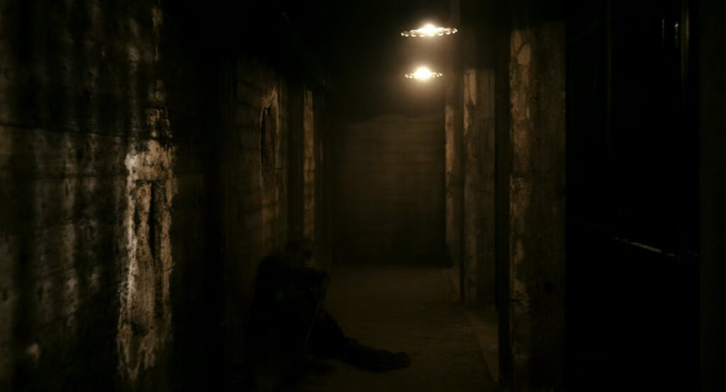 Flashback of Ben in a prison during the war in France.