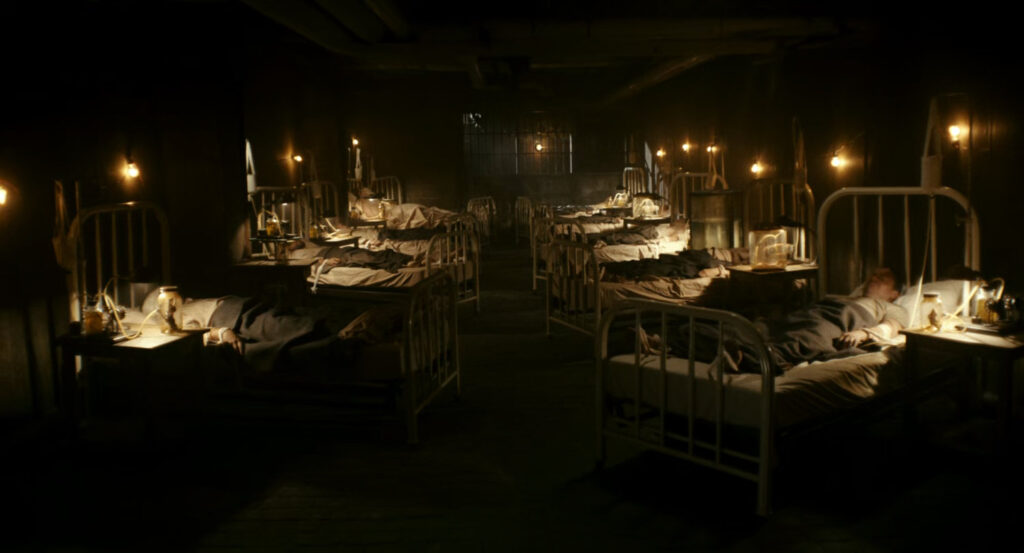 Flashback of men in hospital beds during the war in France.