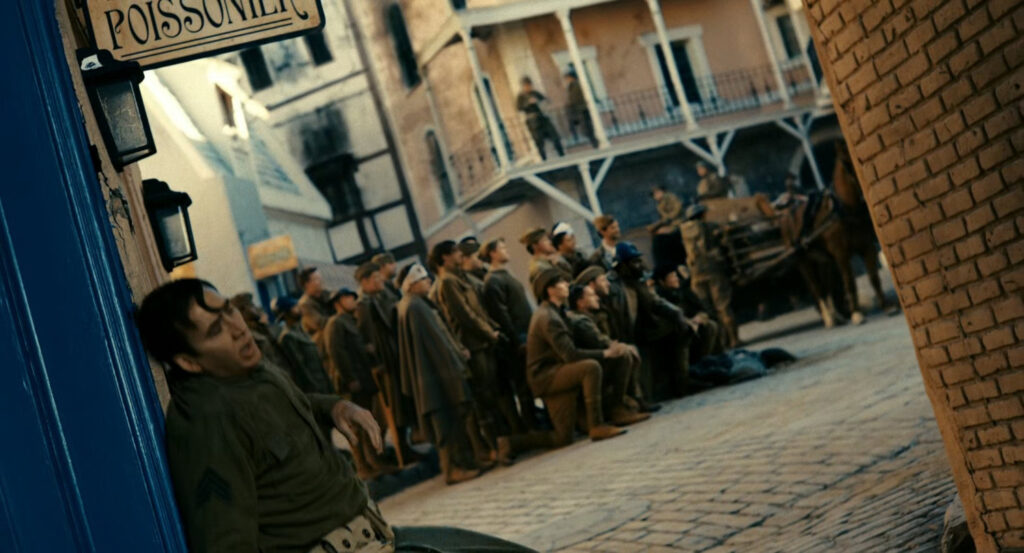 Flashback of Ben passing out by rescued soldiers posing for a photo during the war in France.