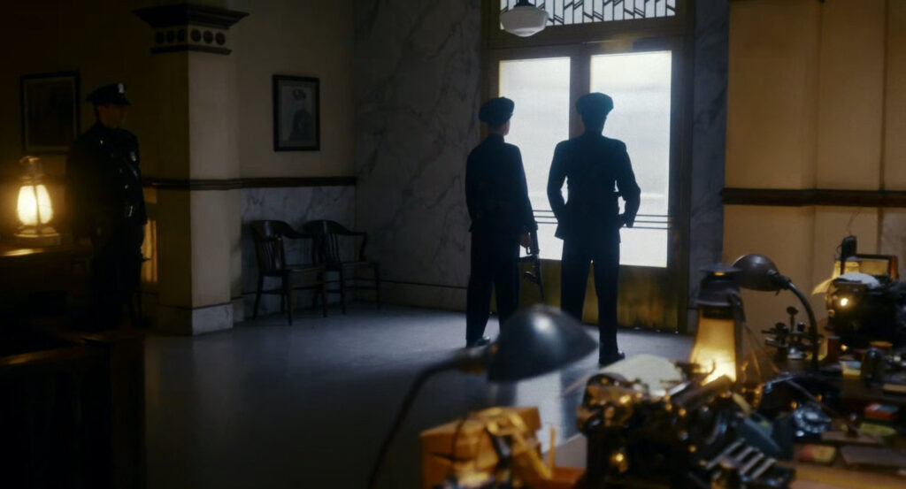 Police officers stand guard in police station.