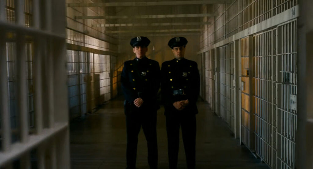 Police officers stand guard in the jail area of police station.