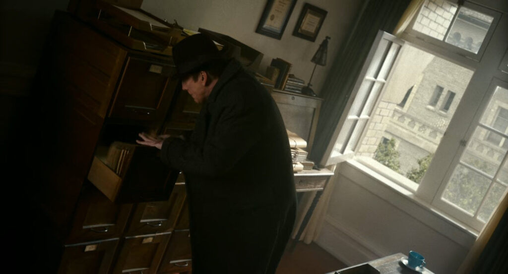 Ben looking through files in Dr. Faber's office of the VA Hospital.