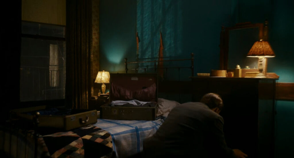 Ben packing a suitcase in his apartment.