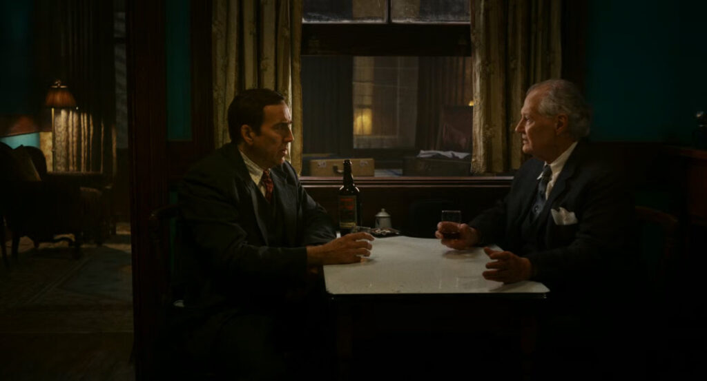 Ben and Ogden having a drink in Ben's apartment.