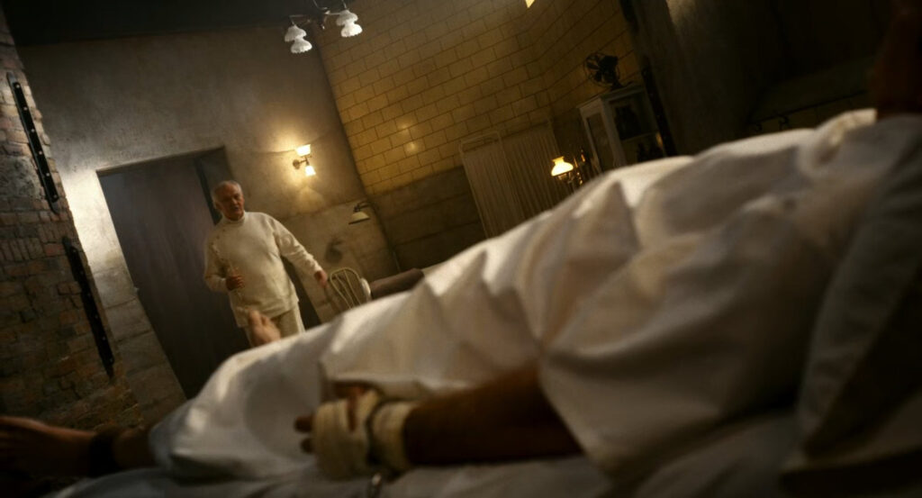 Ogden approaches a restrained Ben in Faber's Secret Lab.