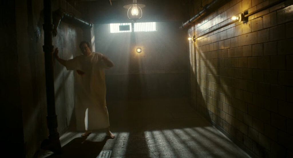 An injured Ben stumbling in the hallway of Faber's Secret Lab.