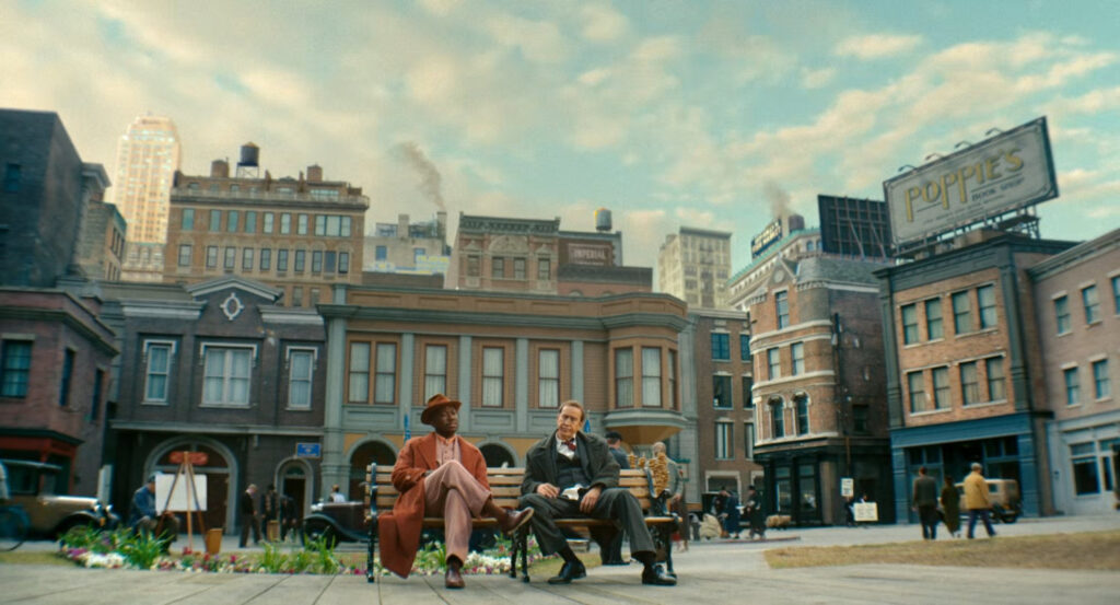 Ben and Robbie sitting in a river side park.